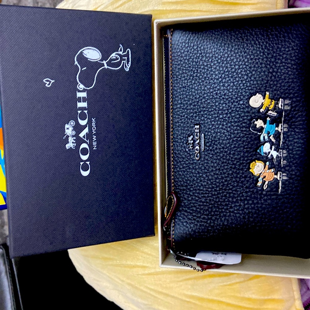 Brand new….still in original box snoopy wristlet.